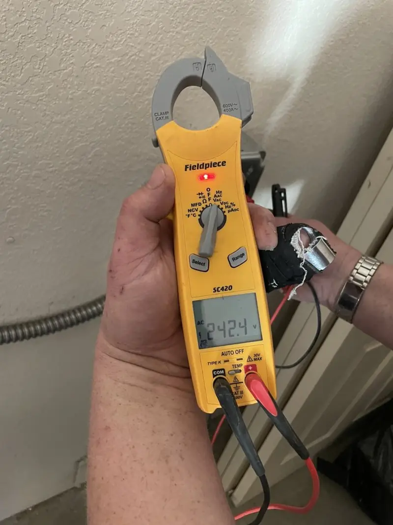 Voltage testing with clamp meter during Electrical Installation Services in Peru